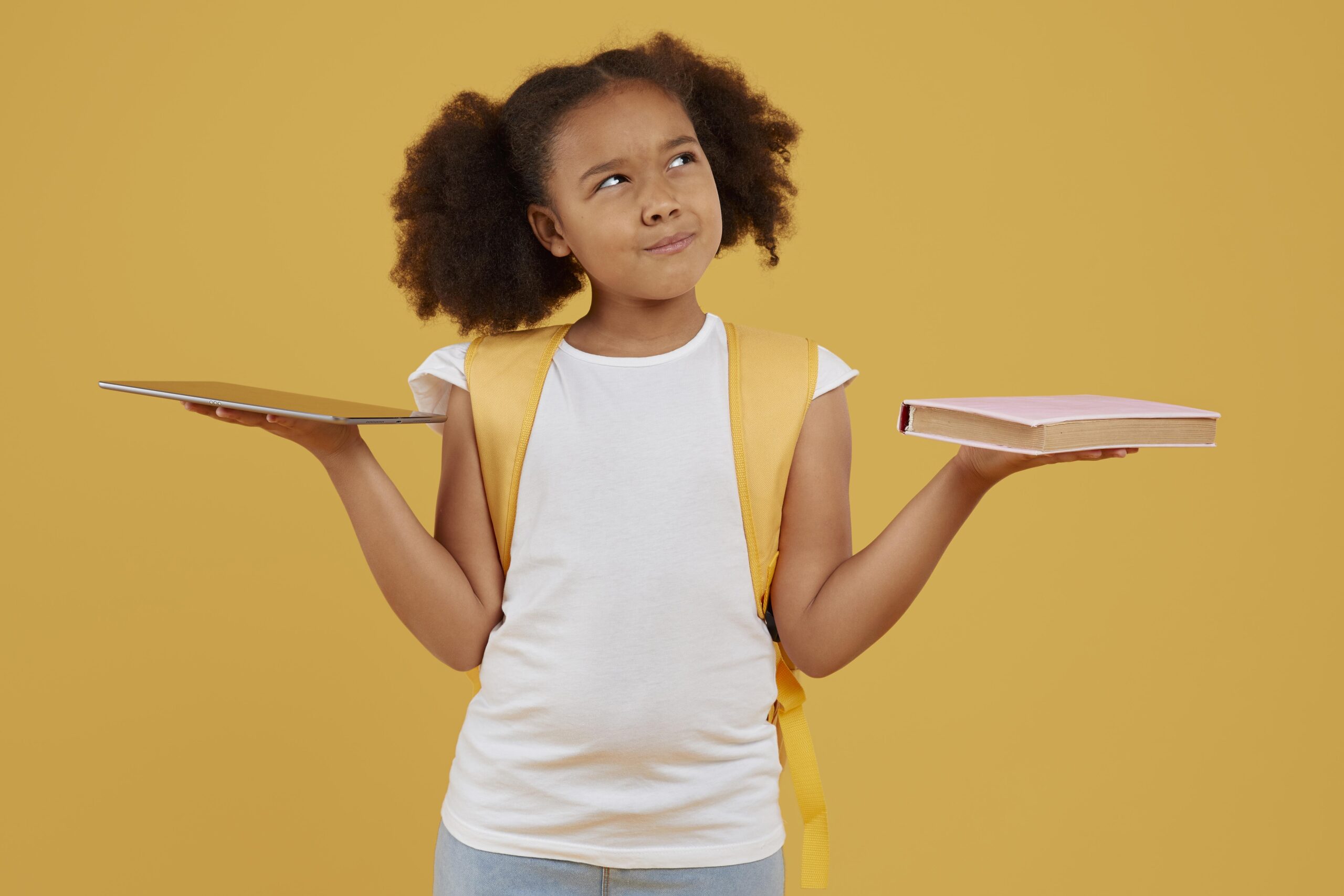 small school girl choosing tablet book 2 scaled